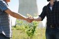 Two power line tower workers with handshaking. Royalty Free Stock Photo