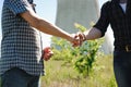 Two power line tower workers with handshaking Royalty Free Stock Photo