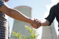 Two power line tower workers with handshaking. Royalty Free Stock Photo