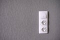 Two power sockets and Light switch on gray wall Royalty Free Stock Photo