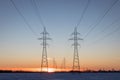 Two Power Transmission Towers Against a Prairie Sunset Royalty Free Stock Photo