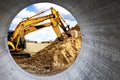 Two powerful excavators work at the same time on a construction site, sunny blue sky in the background. Construction equipment for