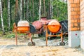 Two powerful industrial concrete mixers at a construction site. Mixing concrete and mortar on site. Construction equipment