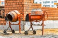 Two powerful industrial concrete mixers at a construction site. Mixing concrete and mortar on site. Construction equipment