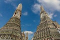 Two prangs, Wat Arun, Bangkok. Blue sky, clouds behind. Royalty Free Stock Photo