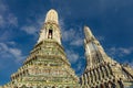 Two prangs, Wat Arun, Bangkok. Colorful decorations blue sky and clouds in background. Royalty Free Stock Photo