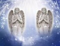 Two praying angels with GodÃÂ´s rays of Light with blue mystic background