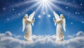 Two praying angels with rays of light over blue sky with stars with copy space in center Royalty Free Stock Photo
