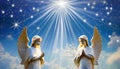 Two praying angels with rays of light over blue sky with stars with copy space in center Royalty Free Stock Photo