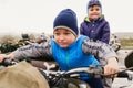 Two boys playing on a retro motorcycle Royalty Free Stock Photo