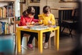 Two preschool girls with Down syndrome holding colorful pencils Royalty Free Stock Photo