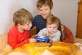 Two preschool or school kids boys, siblings and brothers and little baby girl sister having fun after school day playing Royalty Free Stock Photo