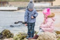 Two preschoolers actively playing on stony beach Royalty Free Stock Photo