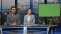 Two presenters broadcasting news at mockup television media channel closeup