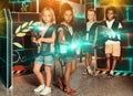 Two preteen girls with friends with laser guns Royalty Free Stock Photo