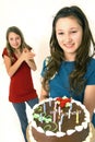 Two preteens with birthday cake