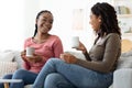 Two pretty black ladies drinking tea at home Royalty Free Stock Photo