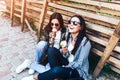 Two long hair brunette girls talking and eating ice cream outdoor Royalty Free Stock Photo