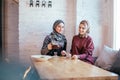 Two caucasian muslim woman drinking tea in cafe Royalty Free Stock Photo