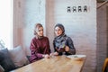 Two caucasian muslim woman drinking tea in cafe Royalty Free Stock Photo