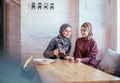 Two caucasian muslim woman drinking tea in cafe Royalty Free Stock Photo