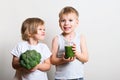 Two pretty fun kids with green smoothies and broccoli. Helthy an Royalty Free Stock Photo