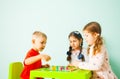 Three kids playing ludo game at home