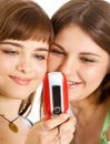 Two pretty girls reading SMS on mobile phone Royalty Free Stock Photo