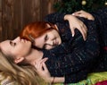 Two pretty lesbians girlfriends kissing and hugging in a cozy atmosphere