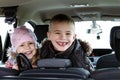 Two pretty little children boy and girl in a car interior Royalty Free Stock Photo