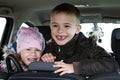 Two pretty little children boy and girl in a car interior Royalty Free Stock Photo