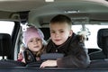 Two pretty little children boy and girl in a car interior Royalty Free Stock Photo