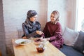 Two Muslim women in cafe, friends meeting Royalty Free Stock Photo