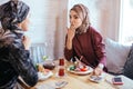 Two Muslim women in cafe, friends meeting Royalty Free Stock Photo