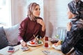 Two Muslim women in cafe, friends meeting Royalty Free Stock Photo