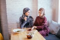 Two Muslim women in cafe, friends meeting Royalty Free Stock Photo