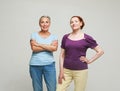 Two pretty old women friends on grey background. Royalty Free Stock Photo