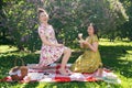 Two pretty pin up ladies having nice picnic in the city park in a sunny day together. girls friends enjoy hot summer weather. beau Royalty Free Stock Photo