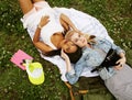 Two pretty school girls on grass happy smiling, best friends having fun together, lifestyle people concept Royalty Free Stock Photo