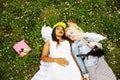 Two pretty school girls on grass happy smiling, best friends having fun together, lifestyle people concept, education Royalty Free Stock Photo
