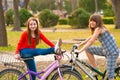 Two pretty teenage girls having fun on bicycles Royalty Free Stock Photo