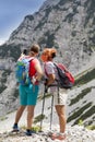 Two pretty women hikers photographing a selfie on mountain peak