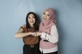 Two pretty young Asian women fist bump each other, showing support and togetherness, friendship concept Royalty Free Stock Photo