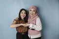 Two pretty young Asian women fist bump each other, showing support and togetherness, friendship concept Royalty Free Stock Photo