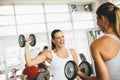 Two pretty young women having workout in gym Royalty Free Stock Photo