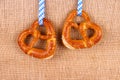 Two pretzel in heart shape on jute background Royalty Free Stock Photo