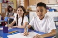 Two primary school pupils in classroom looking to camera