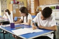 Two primary school pupils working at their desks in class Royalty Free Stock Photo