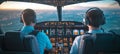 Two Professional Aviators Operating a Cockpit Display in a Modern Aircraft High Above the Clouds Royalty Free Stock Photo