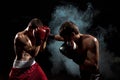 Two professional boxer boxing on black smoky background,